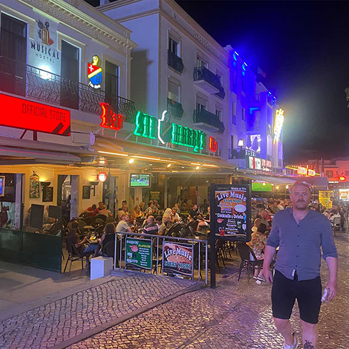  A male member of our staff stood outside Sir Harry's bar Albufeira 