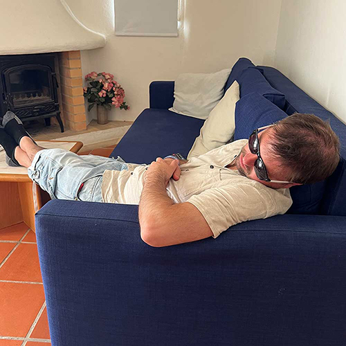 A male member of our team who has fallen asleep in the living room of his apartment at the Balaia Plaza