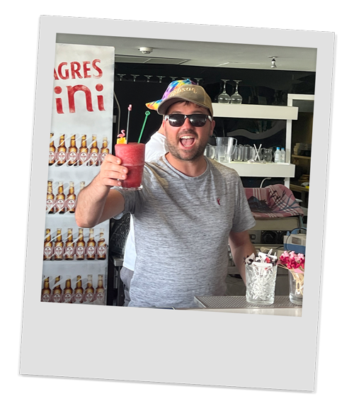 Our male accountant looking pleased with the red coloured cocktail he's made