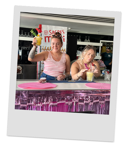 Two female members of our team showing off their cocktail creations