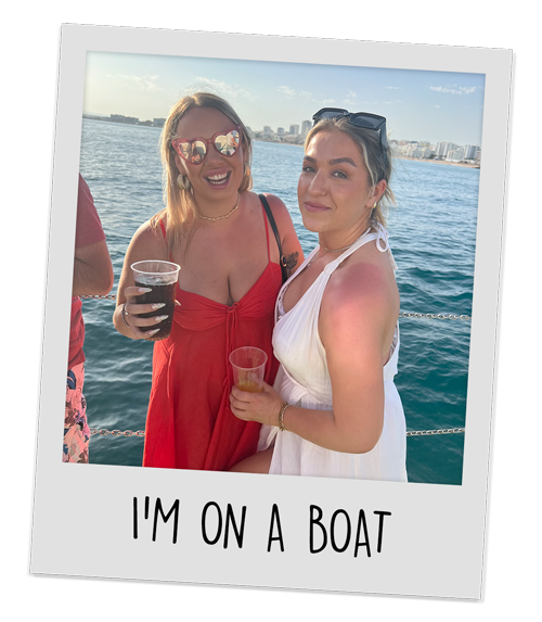 Two female members of our team stood on a boat with drinks in hand with the caption 'I'm on a boat'