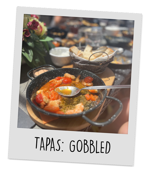 Dishes of half eaten tapas with the caption 'Tapas Gobbled'