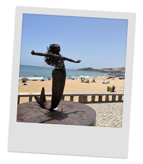 A statue of a mermaid at a beach in Albufeira