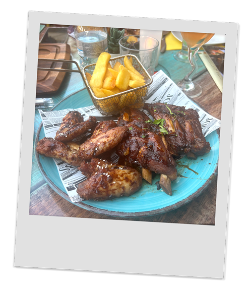A plate of delicious chicken wings, ribs and chips at Ribs and Co 