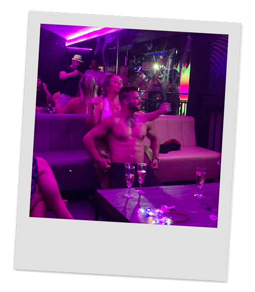 A hot male stripper sitting on a female member of our team in the Grey Goose