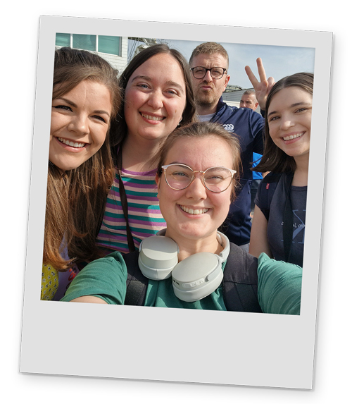 Four female members and a male member of our team posing for a selfie at the airport