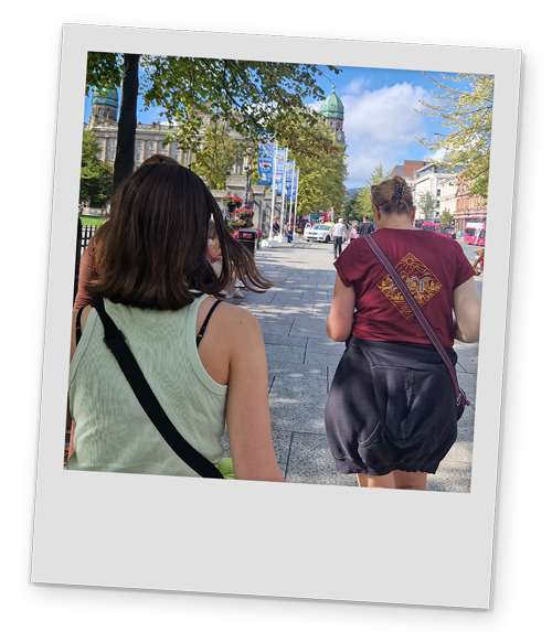 Two female members of our team photographed from behind walking up the street in Belfast