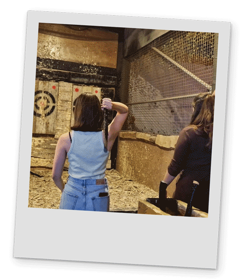 Gif of two female members of our team throwing axes at the targets