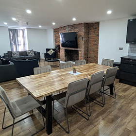 Spacious kitchen and living room with sofas and a TV 