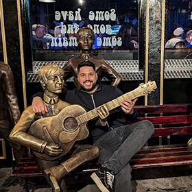  Akash posing with Beatle statues 