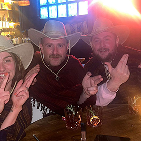  Jade, Adam and Drew making finger guns at the camera whilst wearing cowboy hats 