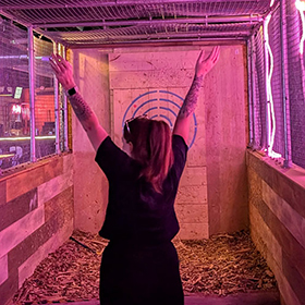  Christie celebrating getting her axe to stick in axe throwing 