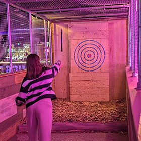  Zoe throwing an axe at a target 