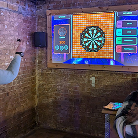  Emma about to throw a dart at an electronic board 