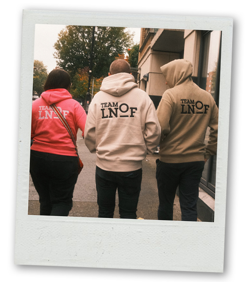 A back view of three members of LNOF staff wearing their LNOF hoodies