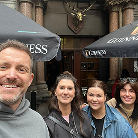 Some members of LNOF posing outside a pub that has a brass stag's head on the front of it 
