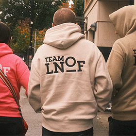  Three members of staff pictured from behind in their LNOF hoodies as they walk through the streets of Dublin 