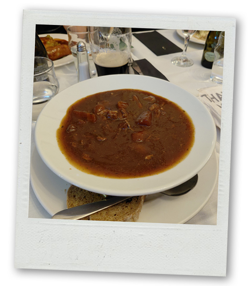 A Guinness beef stew in a bowl served with bread