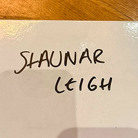  A white board reading Shaunar Leigh 