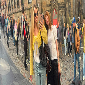  Two members of LNOF staff posing in a mirror that has made them look distorted 