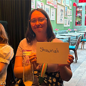  A female member of LNOF staff holding up a whiteboard reading Shawnah 