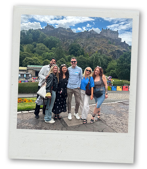 Some LNOf staff posing in front of Edinburgh castle