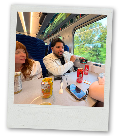 Akash and Rebekah drinking on the train