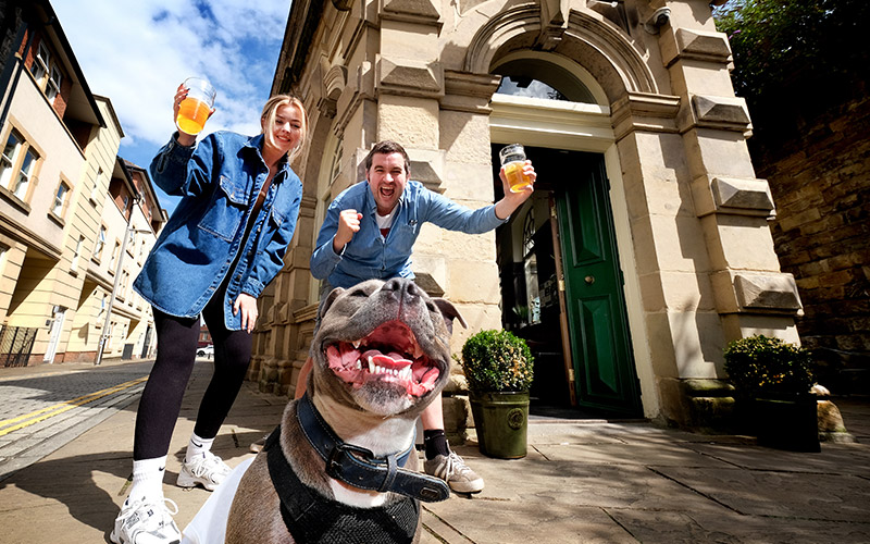Dog and owners enjoying stag do drinks outside The Central Bar, Gateshead