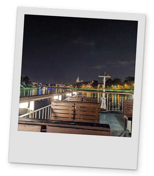 A polaroid style image of the views from the river cruise in Krakow at night