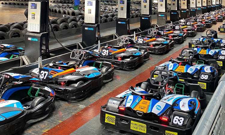 A line of go karts beside a track with on one in them at Teamsport Newcastle