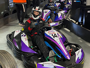 A man in a go kart giving a thumbs up to the camera at Teamsport Newcastle
