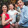 A man in a blue shirt (our MD Matt Mavir), a man in a white shirt and a woman in a red dress with a handbag smiling (Ondrej and Justyna from Prague Weekends). 