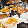  A colourful buffet including chips and chicken dishes. 