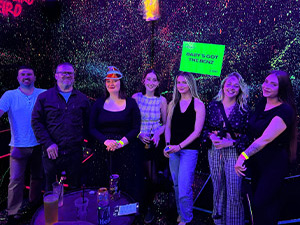 Team LNOF posing by a Junkyard Golf mini golf hole 