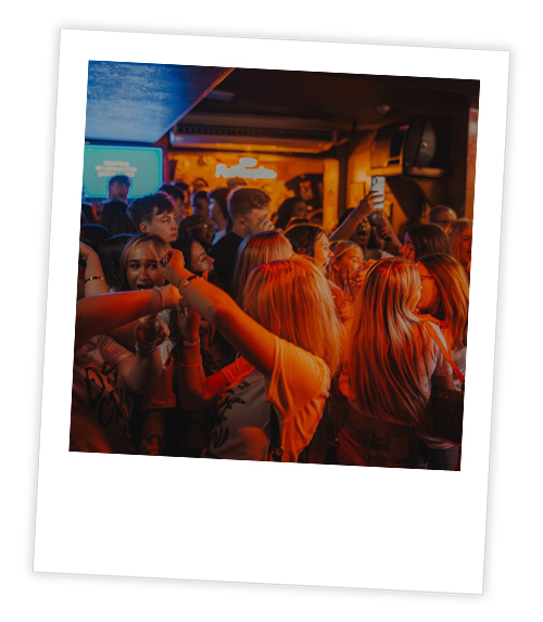 A Polaroid of a large crowd of people in a Bigg Market bar