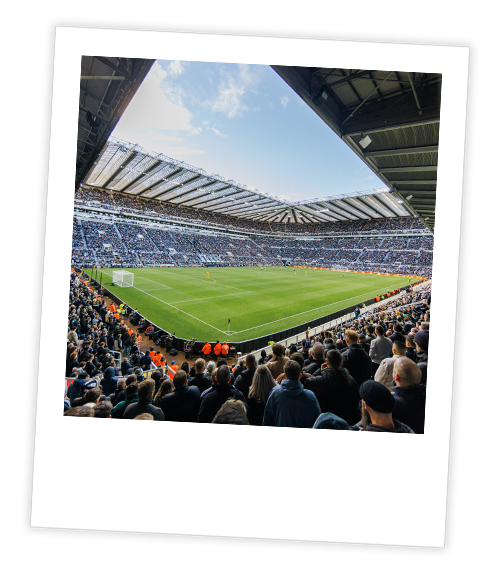 A Polaroid of a football match at St James’ Park at in the day