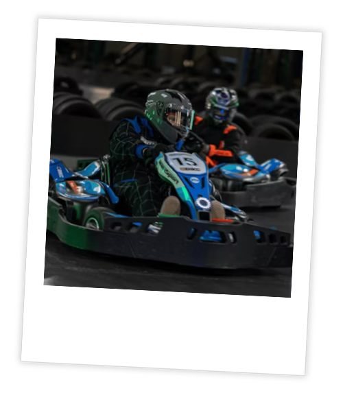 A Polaroid of two men who are go karting