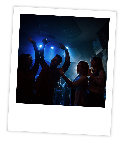 A Polaroid of a group of people dancing in a bar