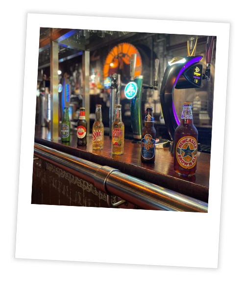 A Polaroid of the exterior of Swarley’s pub which has been captioned with Out On The Toon