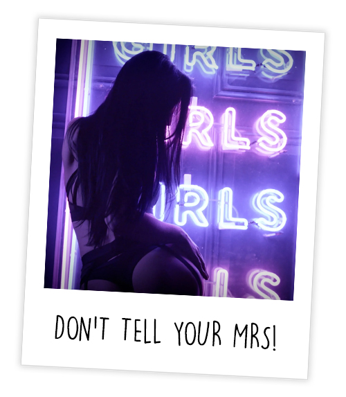 A Polaroid of a stripper next to a sign reading girls girls girls girls