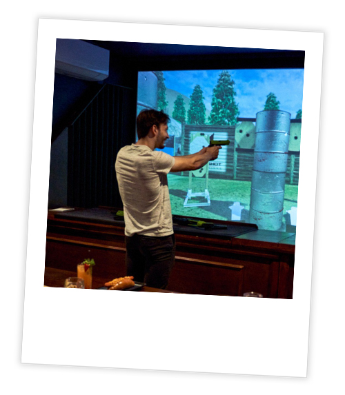 A Polaroid of a man who is shooting a virtual reality gun at Point Blank