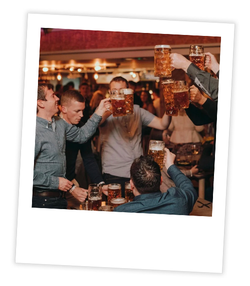 A Polaroid of group of men with big steins of beer partying on the Diamond Strip