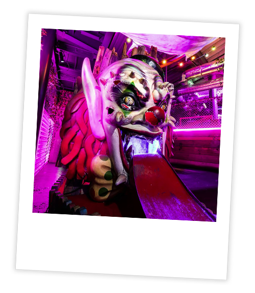 A Polaroid of a mini golf hole that is themed to a creepy clown