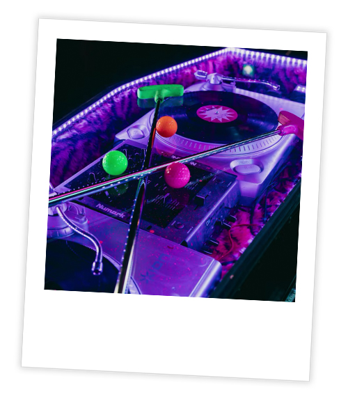 A Polaroid of a mini golf hole that is themed to a record player