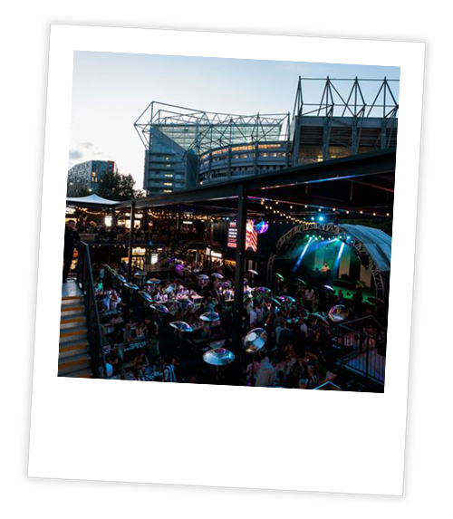 A Polaroid of St James’ Stack in the evening with a band playing
