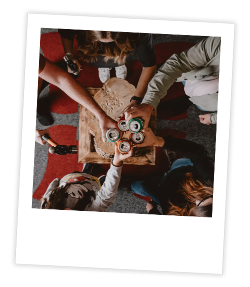 A Polaroid of a group of people enjoying some cans after doing axe throwing