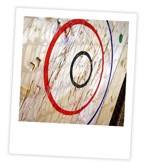 A Polaroid of an axe throwing target
