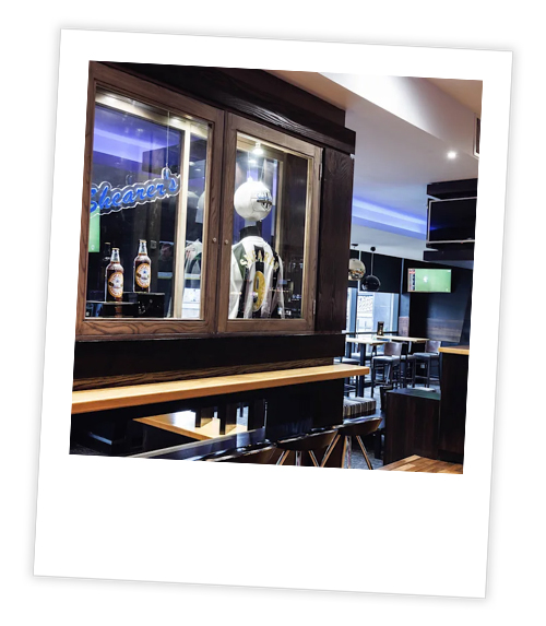 A Polaroid of a case that has some Newcastle FC merch inside it