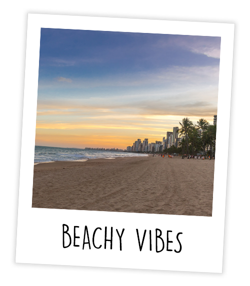 A Polaroid of the beach in Benidorm which is captioned Beachy Vibes