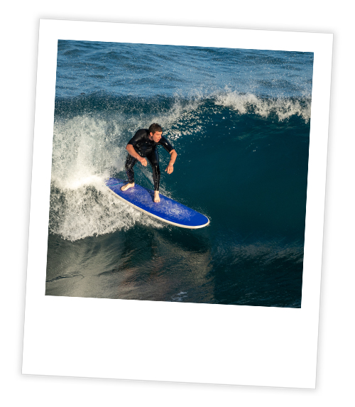 A Polaroid of a man who is surfboarding